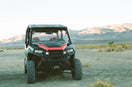 Off-road UTV parked in desert with mountain landscape