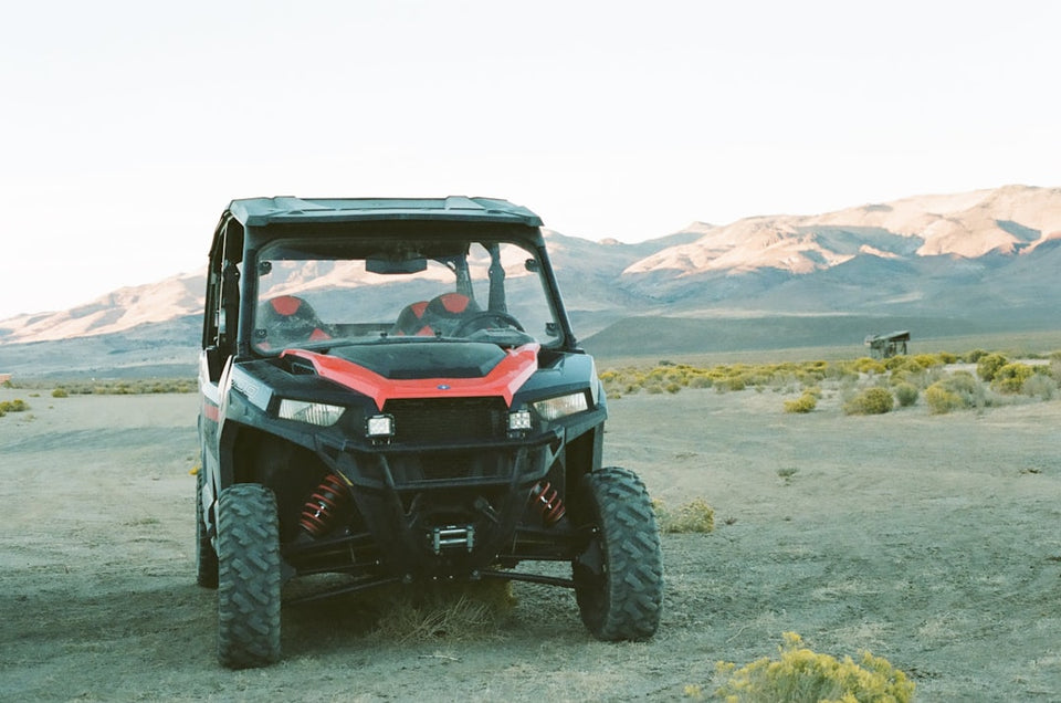 Off-road UTV parked in desert with mountain landscape