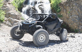 Off-road vehicle on a rocky terrain with a waterfall in the background
Can-Am Maverick R X RS 2ST Stage 1 Spring Kit