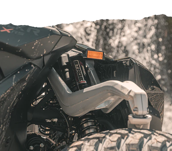Close-up of a vehicle suspension system with Can-Am Maverick R X RS 2ST Stage 1 Spring Kit.